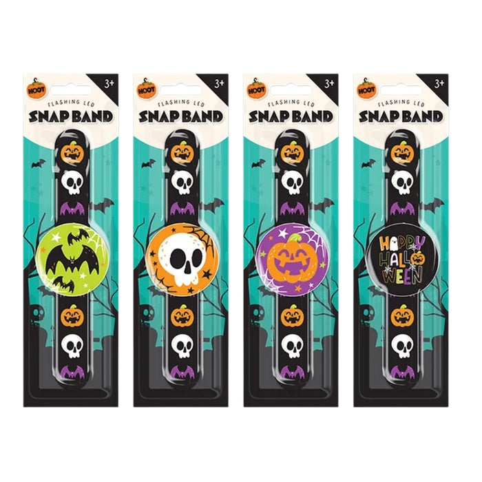 Four Halloween-themed snap band wristlets in retail packaging, each with a different colorful round band design featuring pumpkins, skulls, bats, and one with a 'Halloween' pattern.