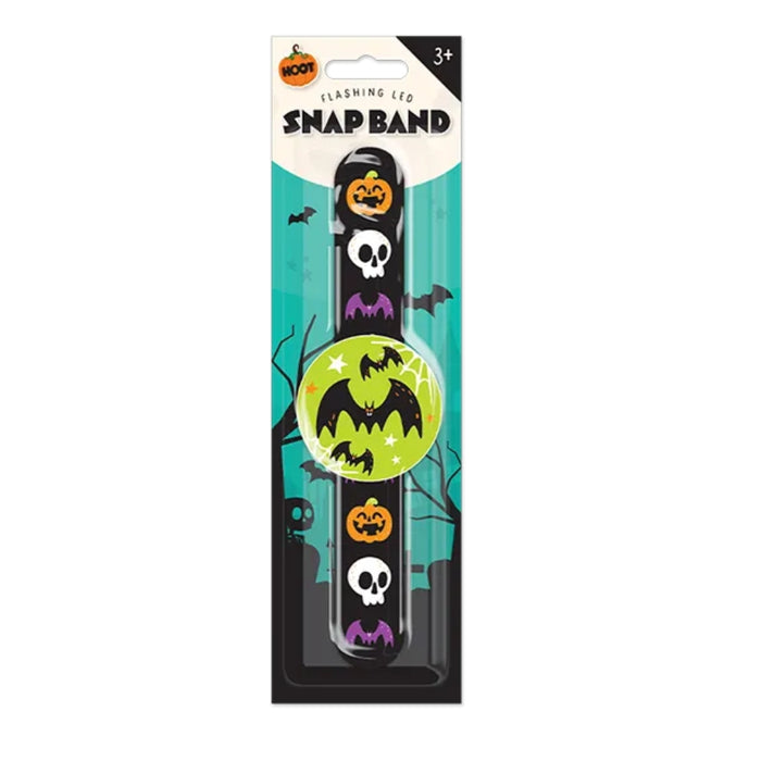 Halloween-themed plastic snap band with a flashing LED, featuring pumpkin, skull, and bat graphics on a black band, packaged in a retail blister pack.