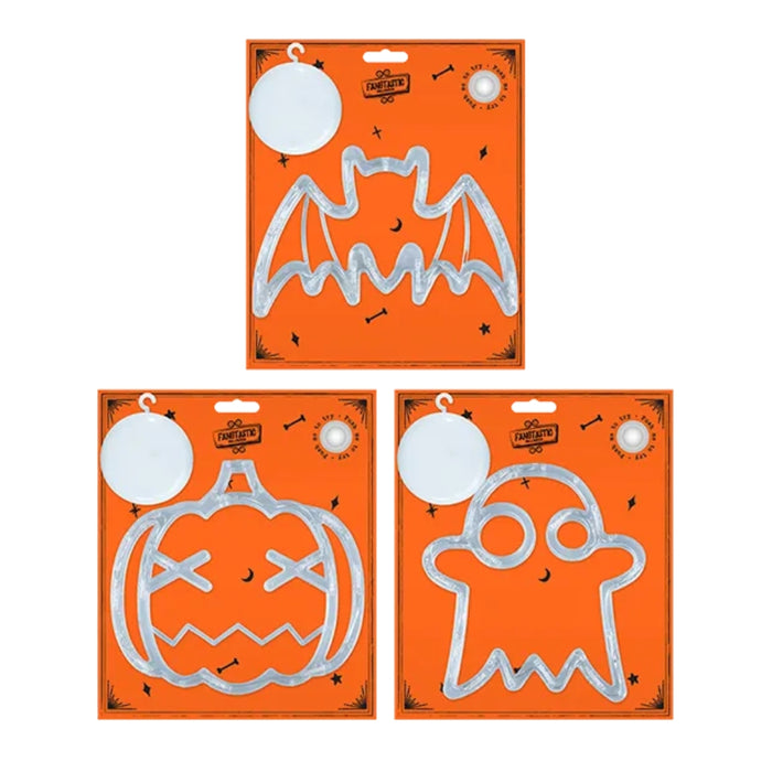 Three Halloween-themed metal cookie cutters in their original orange packaging, featuring bat, pumpkin, and ghost shapes.