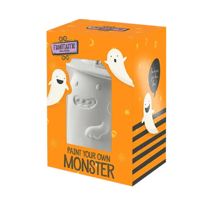 A product box for a 'Fangtastic' brand item featuring a white monster-shaped cup or container visible through a clear window, with orange packaging decorated with ghosts, moons, and the text 'PAINT YOUR OWN MONSTER'.